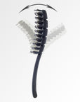 The Flex Brush Petite in black Flexible to meet the contours of your head
